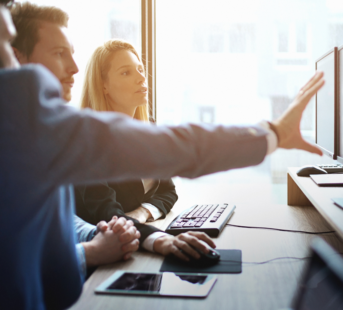 coworkers looking at a computer screen