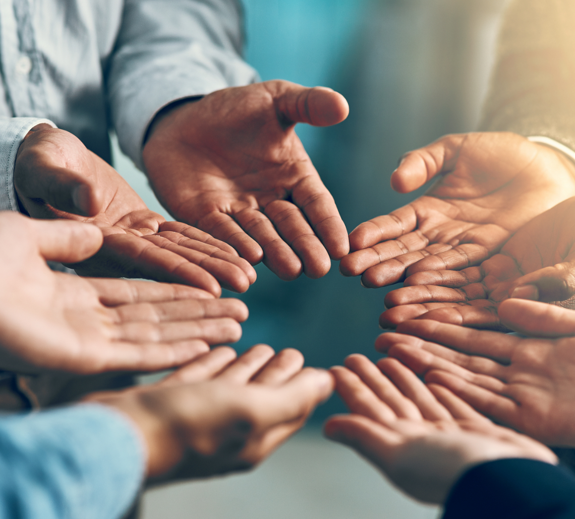group of people with hands in a circle